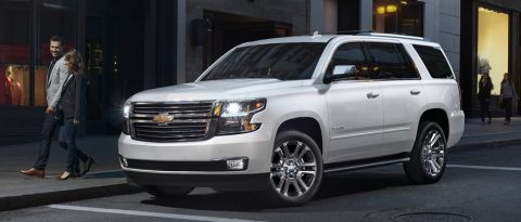 A new pearl Tahoe SUV parked on the street