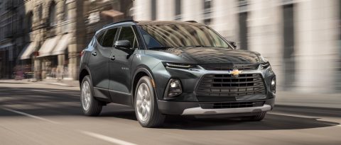 Chevrolet suv driving down a street during a test drive