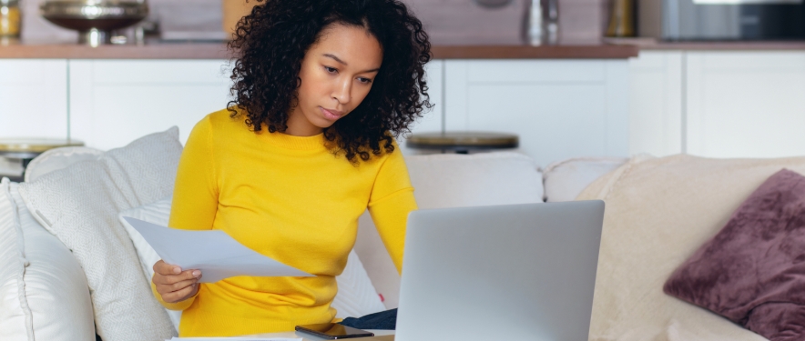 A woman reviews auto loan refinance documents.