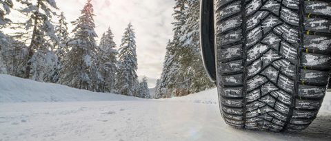 Tire marks in the snow with a text overlay of “Is Your Car Ready For Winter?”