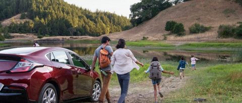 family hiking to campgrounds